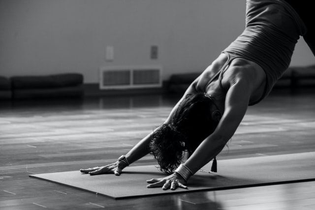 A woman practicing downward-dog